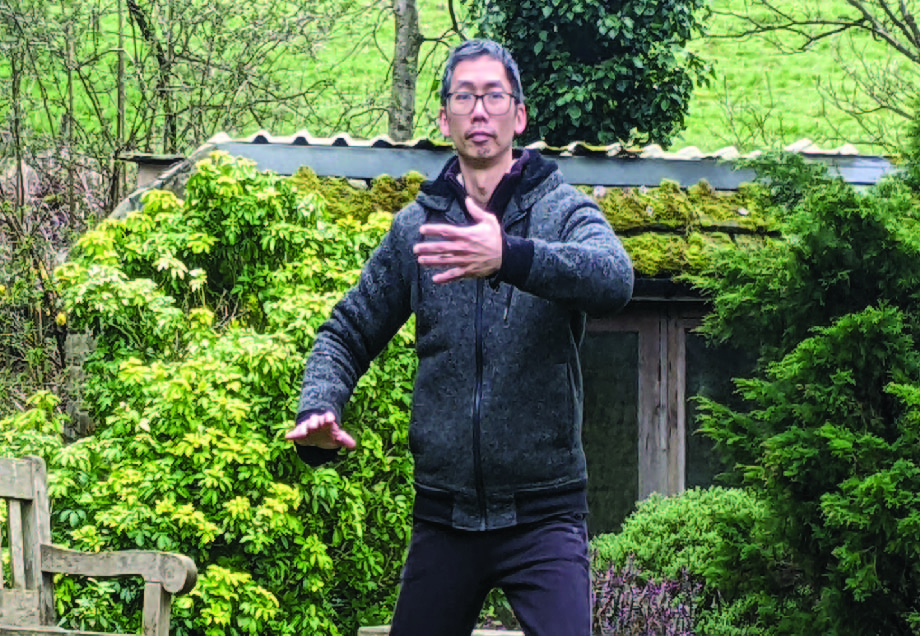 Tai Chi Ward-Off posture demonstrating Peng energy with rounded arms and grounded stance.